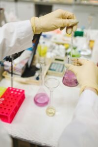 Scientist pouring chemicals for research experiment in a lab setting.